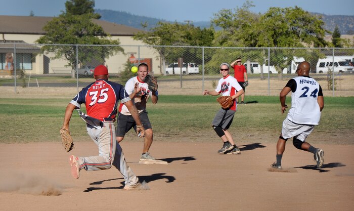 Members of the 9th munitions Squadron attempt a double play during the 2013 Intramural Softball Championships at O’Malley Field on Beale Air Force Base, Calif., Aug. 26, 2013. 9th MUNS defeated 9th Civil Engineer Squadron, 26-9. (U.S. Air Force photo by Staff Sgt. Robert M. Trujillo/Released)
