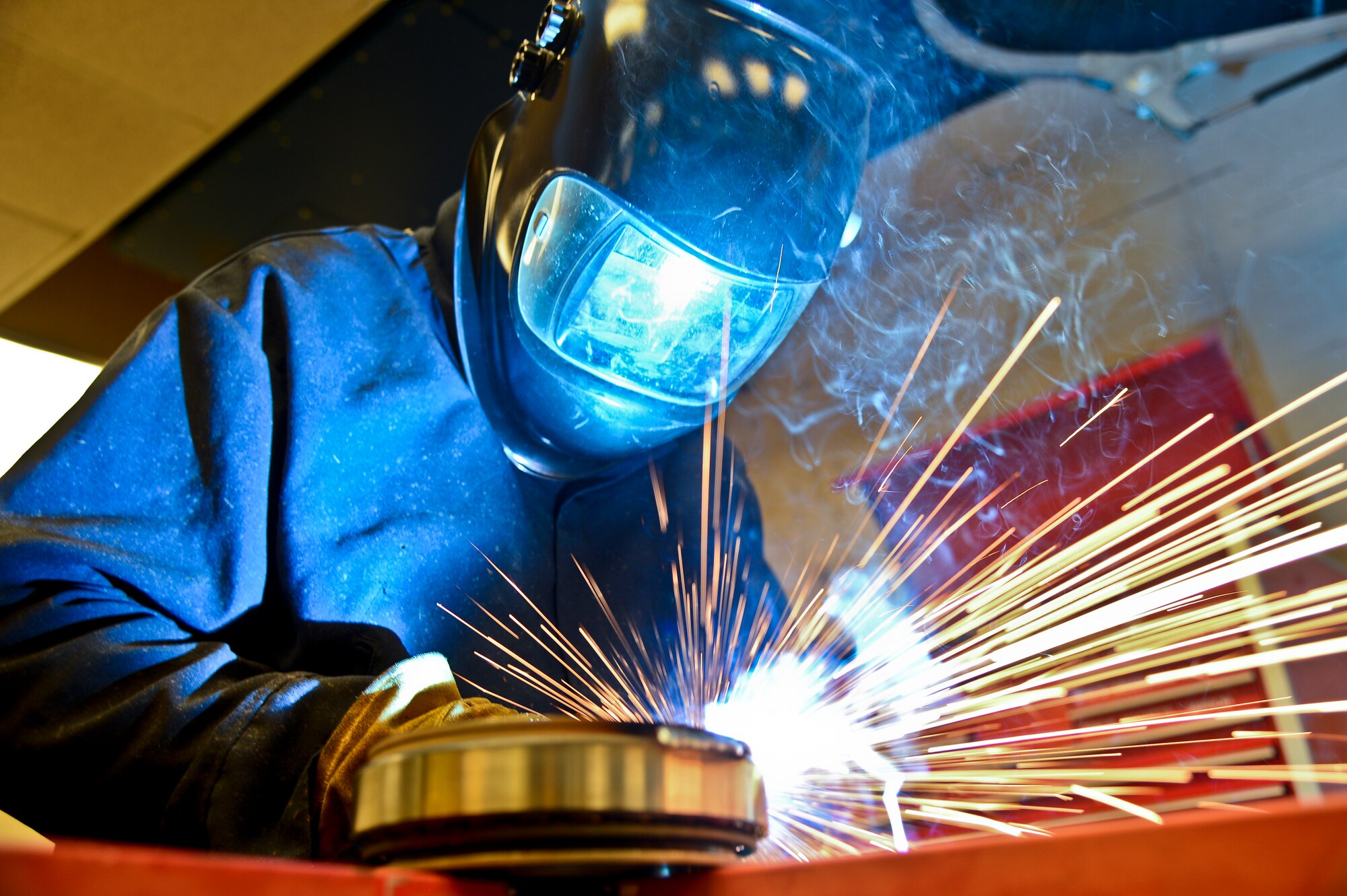 Staff Sgt. Alex Aguayo 6th Maintenance Squadron aircraft metals technician welds together a rotational plate he designed for a paint work station, Aug 22, 2013 at MacDill Air Force Base, Fla. Aguayo is one of two Airmen that co-engineered a way to centrifugally mount a KC-135’s nose and main landing wheel on a rotating base, which reduces a wheel’s paint process by 50 percent. (U.S. Air Force photo by Staff Sgt. Brandon Shapiro/Released) 