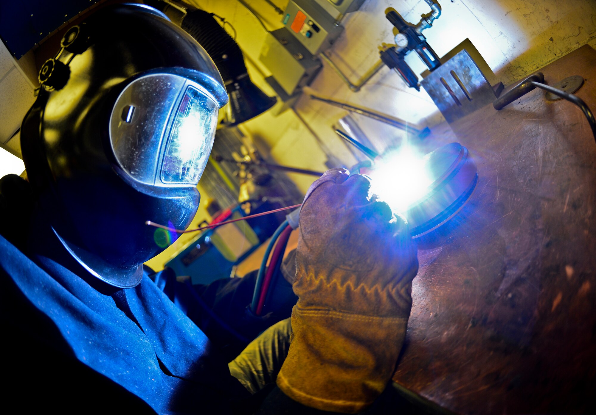 Staff Sgt. Alex Aguayo 6th Maintenance Squadron aircraft metals technician welds together a rotational plate he designed for a paint work station, Aug 20, 2013 at MacDill Air Force Base, Fla. Aguayo is one of two Airmen that co-engineered a way to centrifugally mount a KC-135’s nose and main landing wheel on a rotating base, which reduces a wheel’s paint process by 50 percent. (U.S. Air Force photo by Staff Sgt. Brandon Shapiro/Released) 