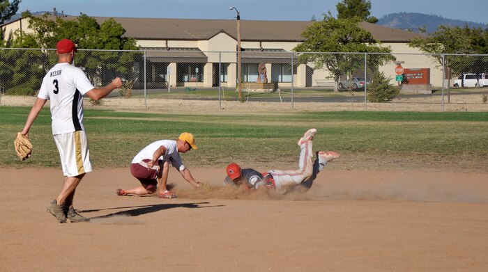 Senior Master Sgt. Michael Riley, 9th Munitions Squadron, slides into second base during Intramural Softball Championships at O’Malley Field on Beale Air Force Base, Calif., Aug. 26, 2013. 9th MUNS defeated 9th Civil Engineer Squadron, 26-9. (U.S. Air Force photo by Staff Sgt. Robert M. Trujillo/Released)
