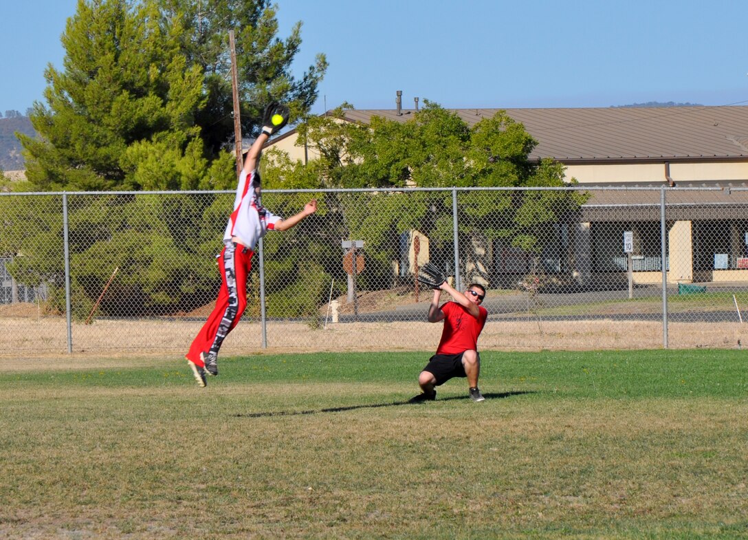 A member of the 9th Munitions Squadron makes a leaping catch during the 2013 Intramural Softball Championships at O’Malley Field on Beale Air Force Base, Calif., Aug. 26, 2013. 9th MUNS defeated 9th Civil Engineer Squadron, 26-9. (U.S. Air Force photo by Staff Sgt. Robert M. Trujillo/Released)