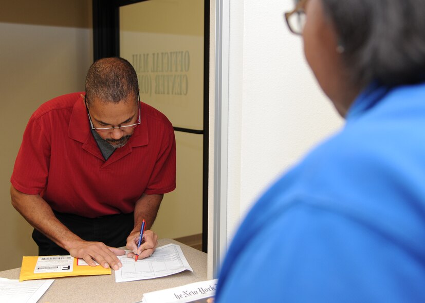 David Lemieux, left, 917th Fighter Group unit program manager, picks up mail at the Official Mail Center on Barksdale Air Force Base, La., Aug. 27, 2013. The OMC distributes and collects all incoming and outgoing mail on Barksdale. (U.S. Air Force photo/Senior Airman Joseph A. Pagán Jr.)