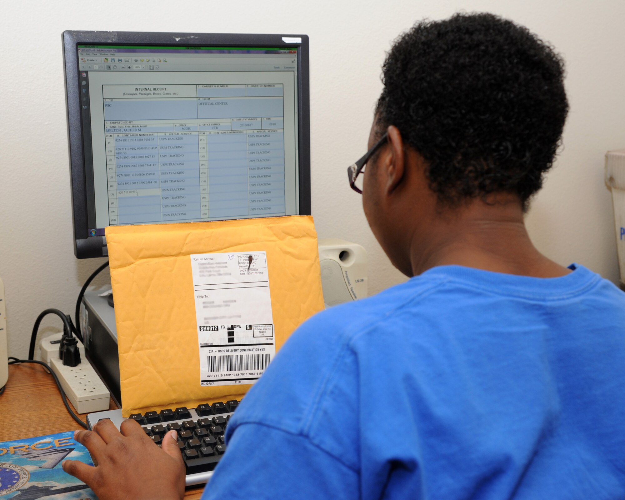 Jacher Melton, Official Mail Center mail clerk, enters the United States Postal Service tracking numbers into a computer for accountability on Barksdale Air Force Base, La., Aug. 27, 2013. Melton maintains all the incoming mail that has a USPS tracking number. From this point, mail gets distributed to either the units or the Postal Service Center, which processes all dormitory mail. (U.S. Air Force photo/Senior Airman Joseph A. Pagán Jr.)