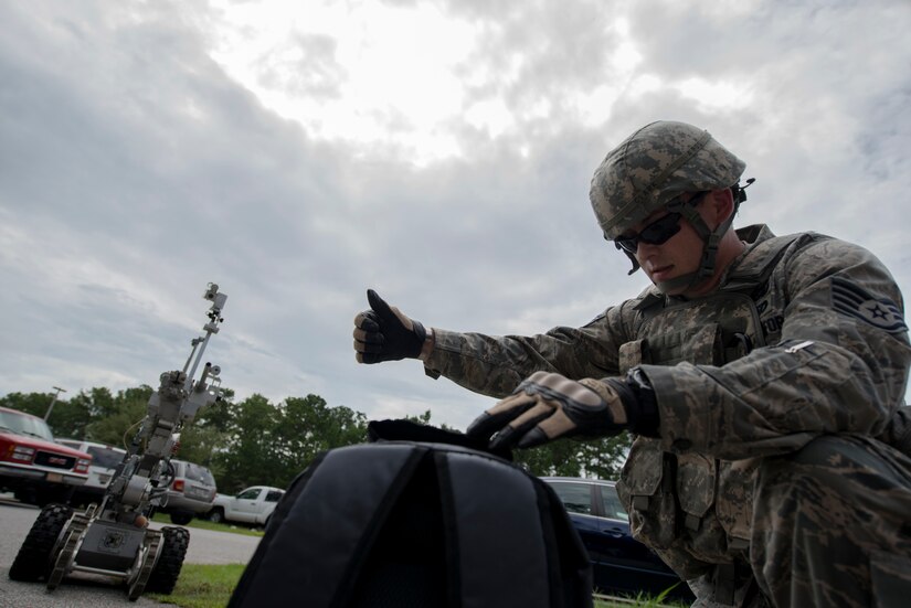 Staff Sgt. Aaron Clark, 628th Civil Engineer Squadron explosive ordnance disposal technician, gives the thumbs up to signal the simulated suspect device is no longer a threat after examination Aug. 22, 2013 at Joint Base Charleston - Weapons Station, S.C. The scenario was one of many that tested JB Charleston to perform their duties under heightened security conditions during a routine security exercise (U.S. Air Force photo/Tech. Sgt. Rasheen Douglas)