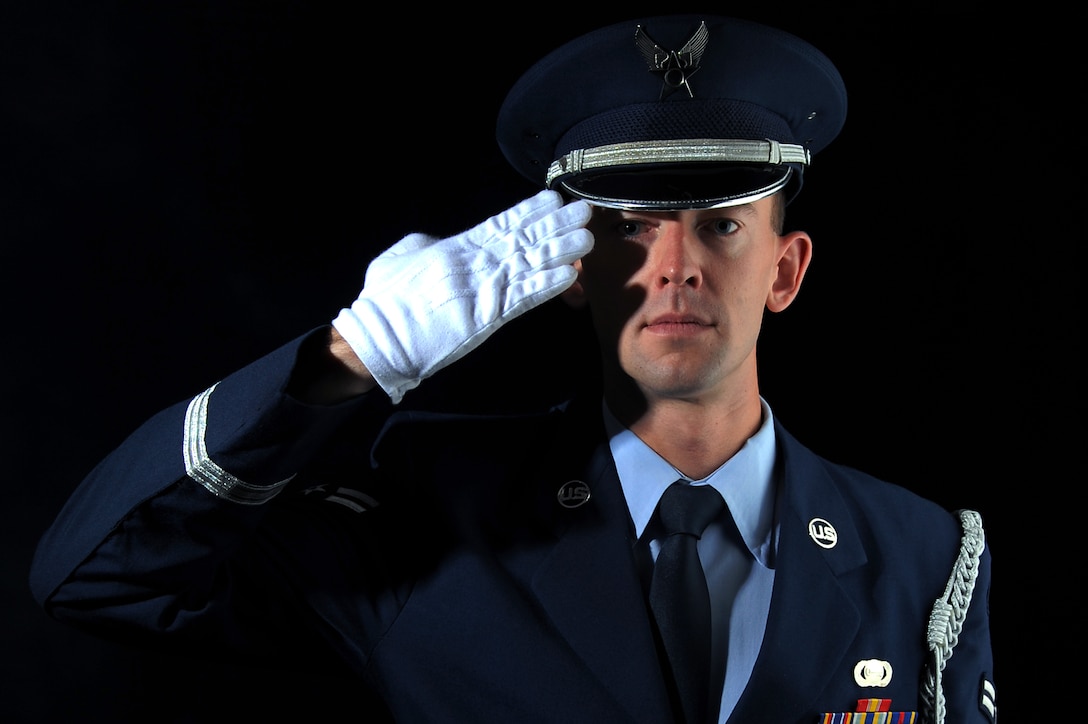 U.S. Air Force Airman 1st Class Ross Heintzkill, , Langley Air Force Base Honor Guard ceremonial guardsman head trainer, performs a salute after graduating LAFBHG at Langley AFB, Va., Aug. 27, 2013. The Base Honor Guard head trainer is responsible for ensuring the Airmen in the incoming flight ia capable of accomplishing their duties. (U.S. Air Force photo by Airman 1st Class Victoria H. Taylor/Released)