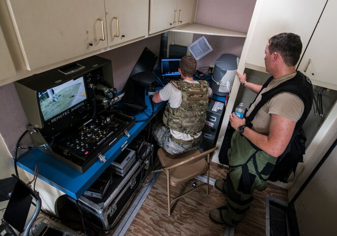 Senior Airman Robert Hardy and Staff Sgt. Aaron Clark, 628th Civil Engineer Squadron explosive ordnance disposal technicians, examine x-ray images that the XRS-3 X-ray generator produced during an exercise Aug. 22, 2013 at Joint Base Charleston - Weapons Station, S.C.  The scenario was one of many that tested JB Charleston to perform their duties under heightened security conditions during a routine security exercise. (U.S. Air Force photo/Tech. Sgt. Rasheen Douglas)