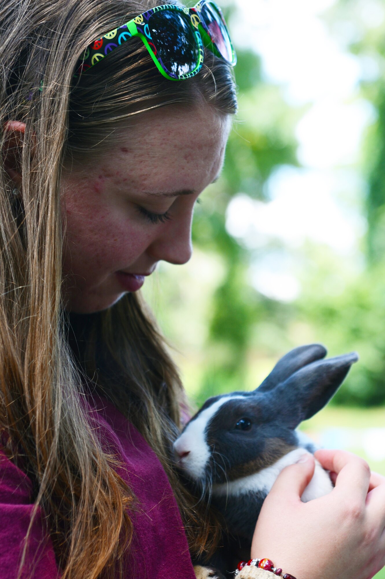 Senior Airman Ashlynn Clemens, 20th Equipment Maintenance Squadron armament crewmember, holds one of the rabbits at the petting zoo during the Shawsome Mega Sunday event at Shaw Air Force Base, S.C., Aug. 25, 2013. The chapel hosted the free fair to promote the morale on base.  were also clowns, bouncy castles, funnel cakes and live music. (U.S. Air Force photo by Airman 1st Class Krystal M. Jeffers/Released)