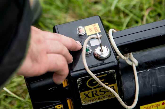 Staff Sgt. Aaron Clark, 628th Civil Engineer Squadron explosive ordnance disposal technician, sets up the XRS-3 X-ray generator to identify any possible hazards of the backpack, which was simulating the suspect device during an exercise on Aug. 22, 2013 at Joint Base Charleston - Weapons Station, S.C. Once x-rays are taken, EOD technicians can verify what type of hazard they're facing. The scenario was one of many that tested JB Charleston to perform their duties under heightened security conditions during a routine security exercise (U.S. Air Force photo/Tech. Sgt. Rasheen Douglas)