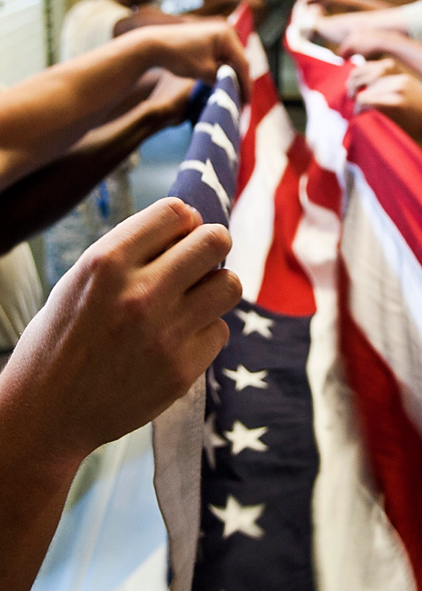 U.S. Air Force Airmen of the Langley Air Force Base Honor Guard ceremonial guardsmen fold the flag during a training session at Langley AFB, Va., Aug. 26, 2013. Throughout their training, the guardsmen are taught standardized ceremonies, which are performed with precise, detailed instructions. (U.S. Air Force photo by Airman 1st Class Victoria H. Taylor/Released)