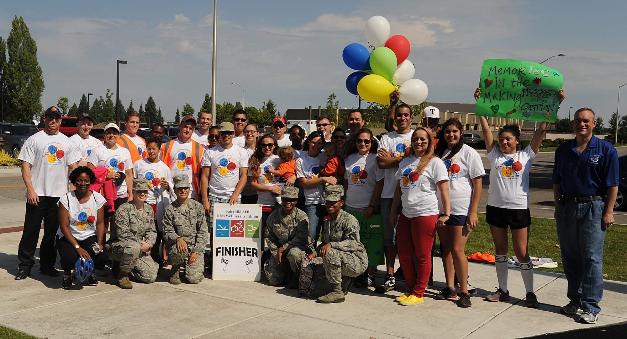 Col. Brian Newberry, 92nd Air Refueling Wing commander, poses for a group photo with Kids Wellness Triathlon volunteers at Fairchild Air Force Base, Wash., Aug. 24, 2013.  Lifelong health was encouraged at the event.  (U.S. Air Force photo by Airman 1st Class Sam Fogleman/Released)