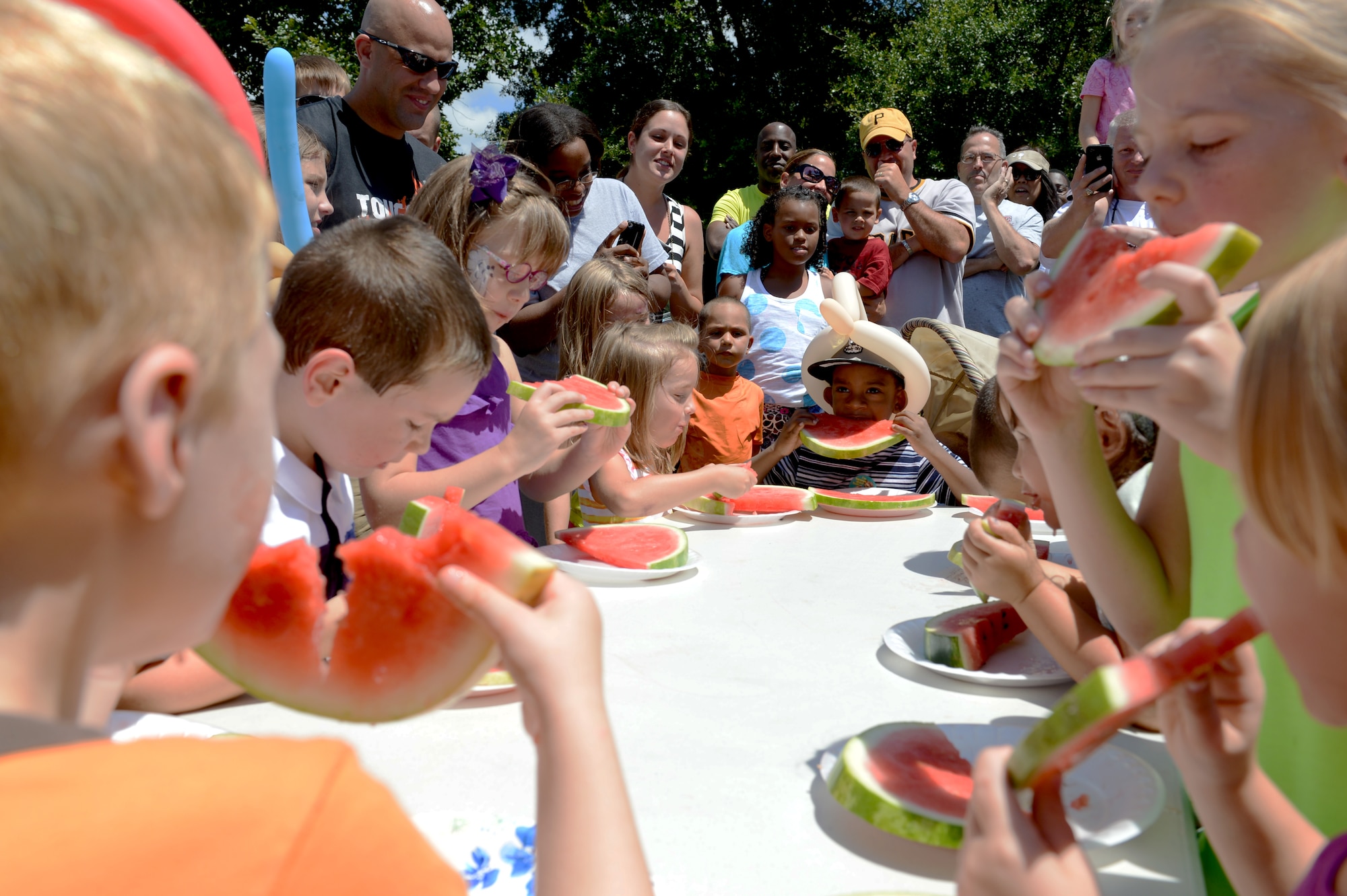 Children compete in a watermelon eating contest during the Shawsome Mega Sunday event at Shaw Air Force Base, S.C., Aug. 25, 2013. The chapel hosted the  free fair to promote the morale on base. There were other events that visitors could participate in like a water balloon toss and a scavenger hunt. (U.S. Air Force photo by Airman 1st Class Krystal M. Jeffers/Released)