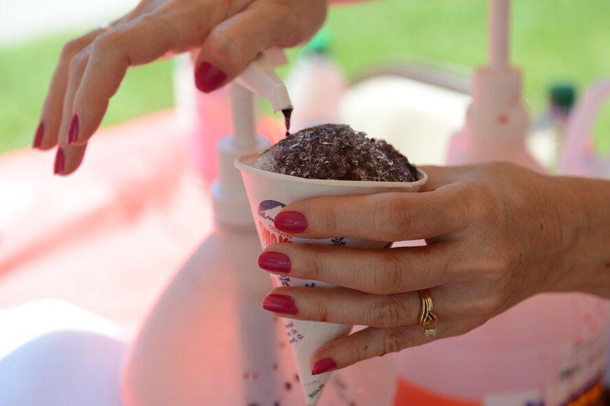 Snow cones and other free food like funnel cakes were available during the Shawsome Mega Sunday event at Shaw Air Force Base, S.C., Aug. 25, 2013. The chapel hosted the free fair to promote the morale on base. In addition to free food, the event had a variety of free attractions like bouncy castles, a petting zoo and a watermelon eating contest. (U.S. Air Force photo by Airman 1st Class Krystal M. Jeffers/Released)