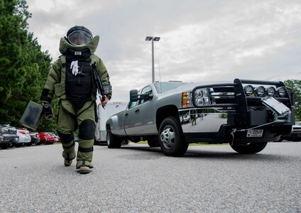 Staff Sgt. Aaron Clark, 628th Civil Engineer Squadron explosive ordnance disposal technician, walks toward the simulated suspect device with his bomb suit and equipment to examine the device further during an anti-terrorism exercise on Aug. 22, 2013, at Joint Base Charleston - Weapons Station.  The scenario was one of many that tested JB Charleston to perform their duties under heightened security conditions during a routine security exercise. (U.S. Air Force photo/Tech. Sgt. Rasheen Douglas)