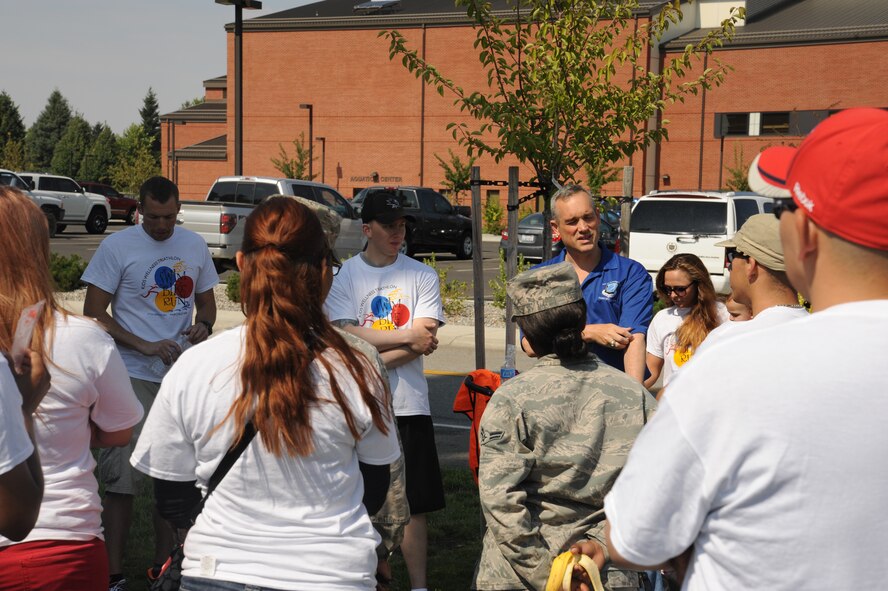 Col. Brian Newberry, 92nd Air Refueling Wing commander, speaks with organizers and volunteers at the conclusion of the Kids Wellness Triathlon at Fairchild Air Force Base, Wash., Aug. 24, 2013.  The event was organized by the 92nd Medical Group.  (U.S. Air Force photo by Airman 1st Class Sam Fogleman/Released)