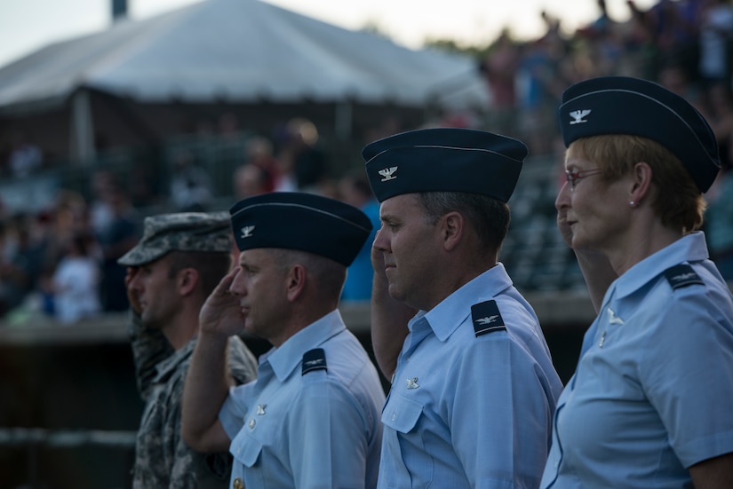 Second from left to right) Col. Scott Sauter, 315th Airlift Wing vice commander, Col. Frederick Boehm, 437th Operations Group commander, and Col. Judith Hughes, 628th Medical Group commander, salute as the National Anthem plays before start of the  Charleston RiverDogs Military Appreciation Night game Aug. 21, 2013, at the Joseph P. Riley Jr. park in Charleston, S.C. The Charleston RiverDogs hosted Military Appreciation night to show their support for the local military. (U.S. Air Force photo/Tech. Sgt. Rasheen Douglas)




