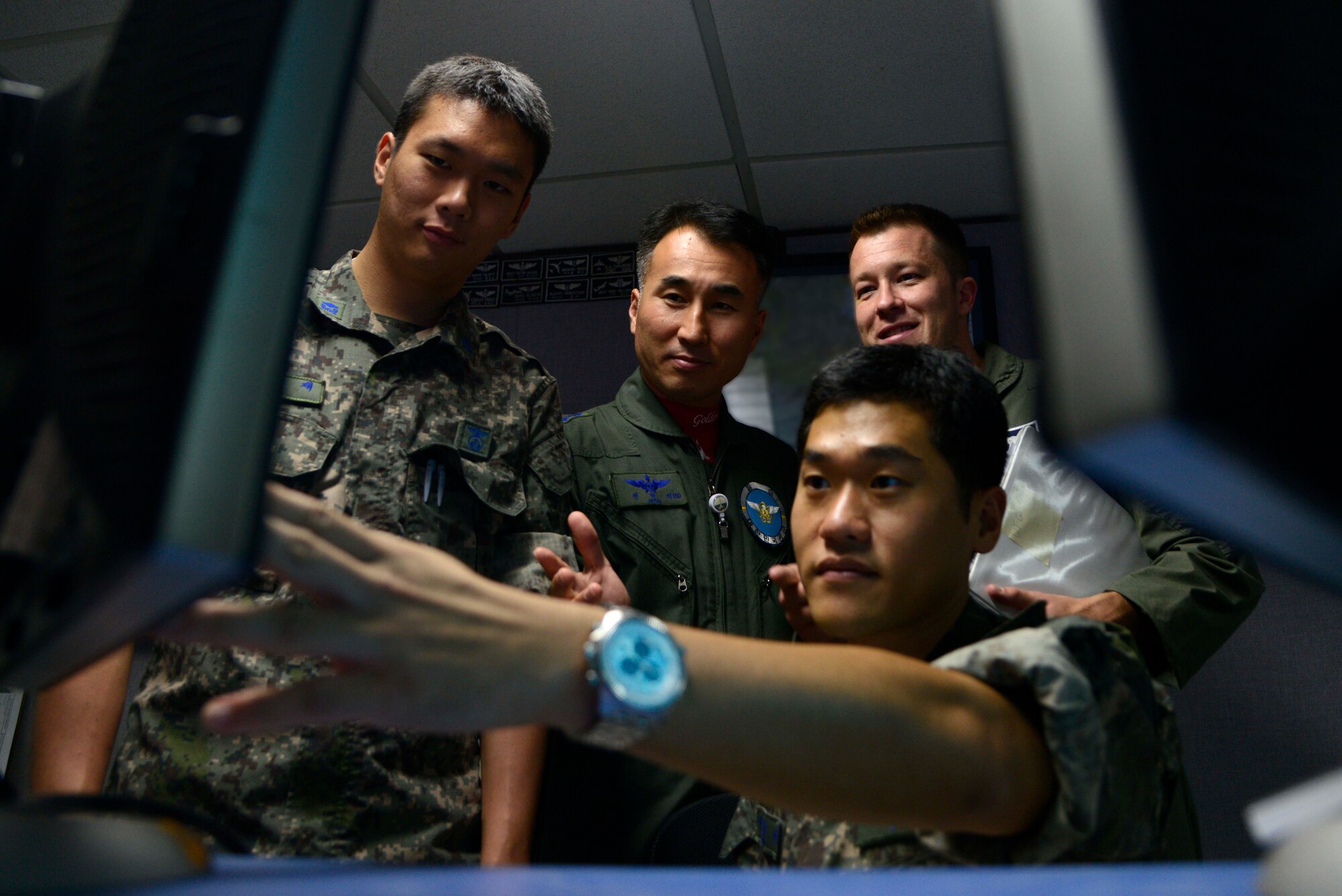 Republic of Korea Air Force 2nd Lt. Jae Joo Sung (foreground) monitors a global positioning system and satellite communications link in the Air Operations Center at Osan Air Base, ROK, Aug. 19, 2013, during Ulchi Freedom Guardian 2013. (Left to right) ROKAF Capt. Kyun Woo Hong and ROKAF Lt. Col. Hyeon Seock Jeon, along with U.S. Air Force Capt. Michael Crum, look on during the annual exercise designed to ensure readiness to defend the ROK and sustain the capabilities that strengthen the ROK-U.S. Alliance. Hong, Jeon and Sung are assigned to the Space Coordination Team and Crum is assigned to the 701st Combat Operations Squadron, March Air Reserve Base, Calif. (U.S. Air Force photo/Staff Sgt. Sheila deVera)