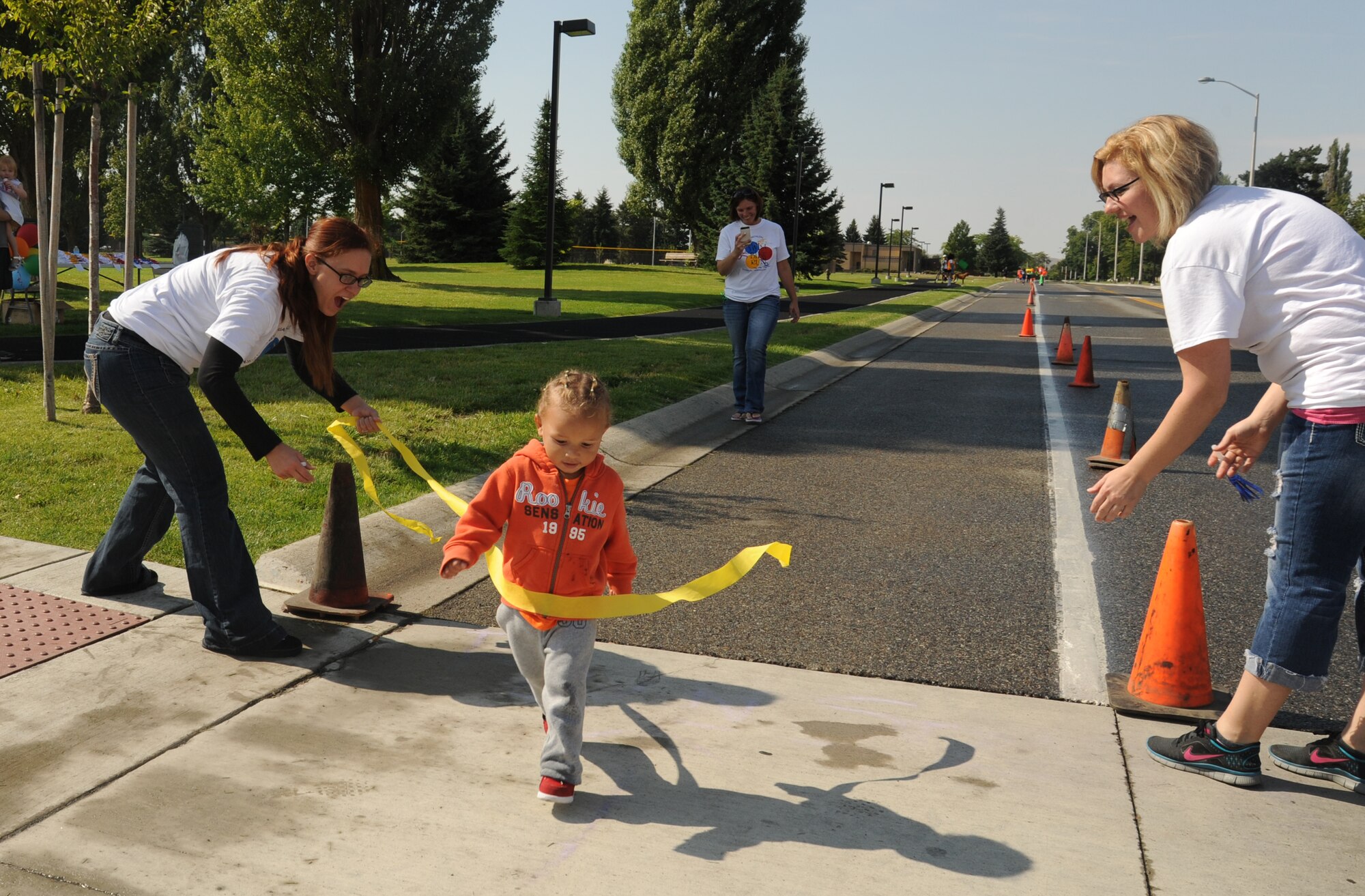 Jayden Bussey crosses the finish line of the Kids Wellness Triathlon at Fairchild Air Force Base, Wash., Aug. 24, 2013.  The event was open to kids 15 years old and under.  (U.S. Air Force photo by Airman 1st Class Sam Fogleman/Released)
