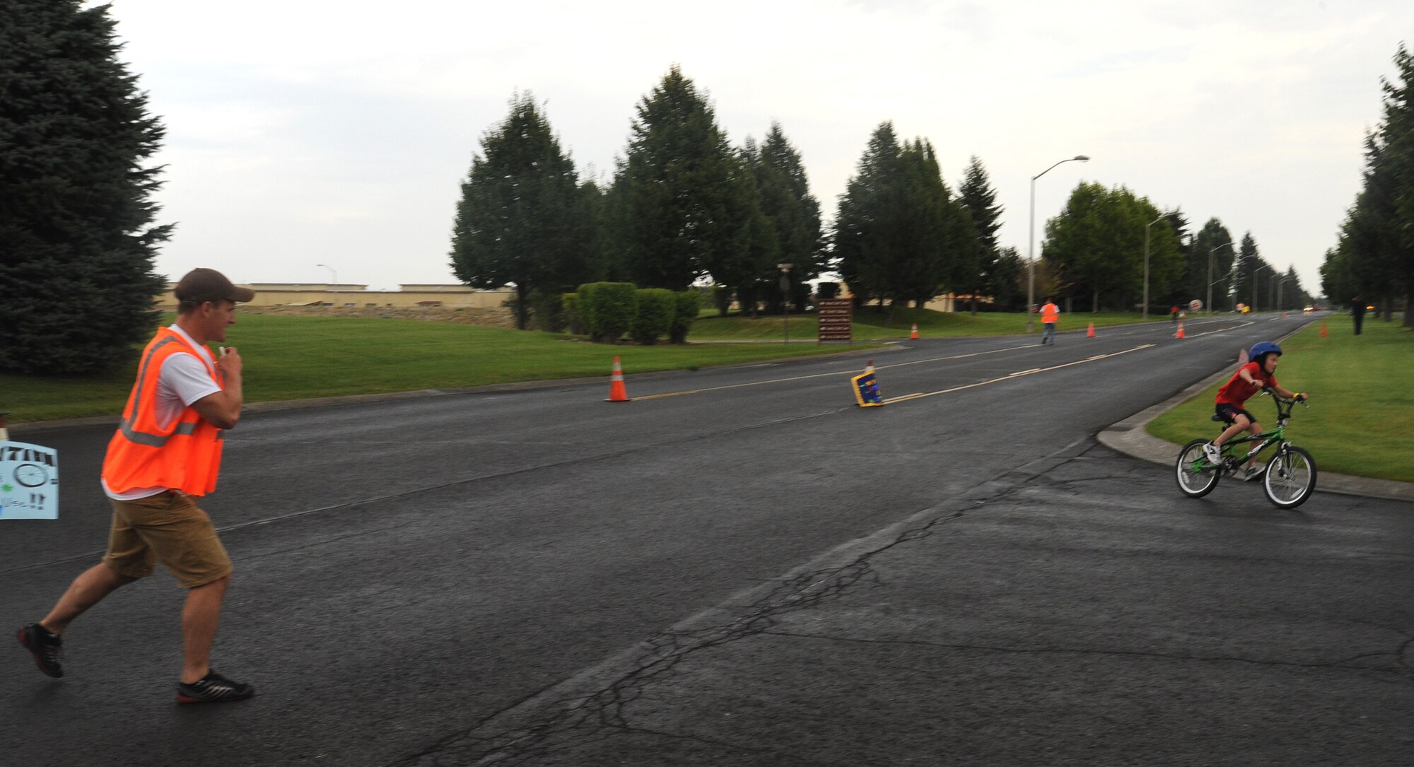 Road guards direct participants during the biking segment of the Kids Wellness Triathlon at Fairchild Air Force Base, Wash., Aug. 24, 2013.  No one was injured at the event.  (U.S. Air Force photo by Airman 1st Class Sam Fogleman/Released)