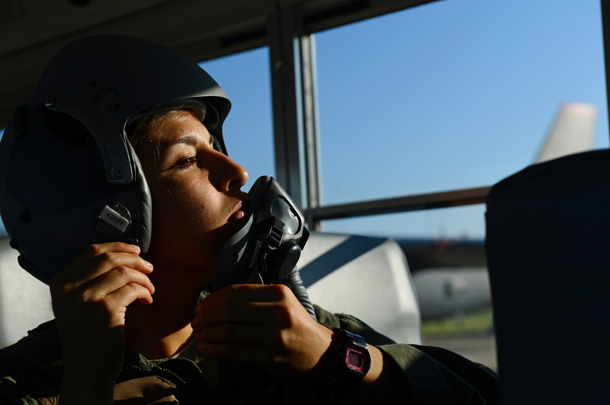 Capt. Marisa Whitaker, 20th Bomb Squadron B-52H Stratofortress copilot, dons a light-weight helmet on Barksdale Air Force Base, La., Aug. 26, 2013. In order to get to the aircraft quickly, aircrew are shuttled by bus to save time. (U.S. Air Force photo/Senior Airman Micaiah Anthony)
