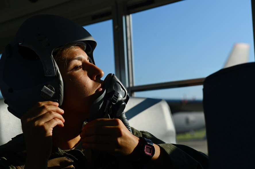Capt. Marisa Whitaker, 20th Bomb Squadron B-52H Stratofortress copilot, dons a light-weight helmet on Barksdale Air Force Base, La., Aug. 26, 2013. In order to get to the aircraft quickly, aircrew are shuttled by bus to save time. (U.S. Air Force photo/Senior Airman Micaiah Anthony)
