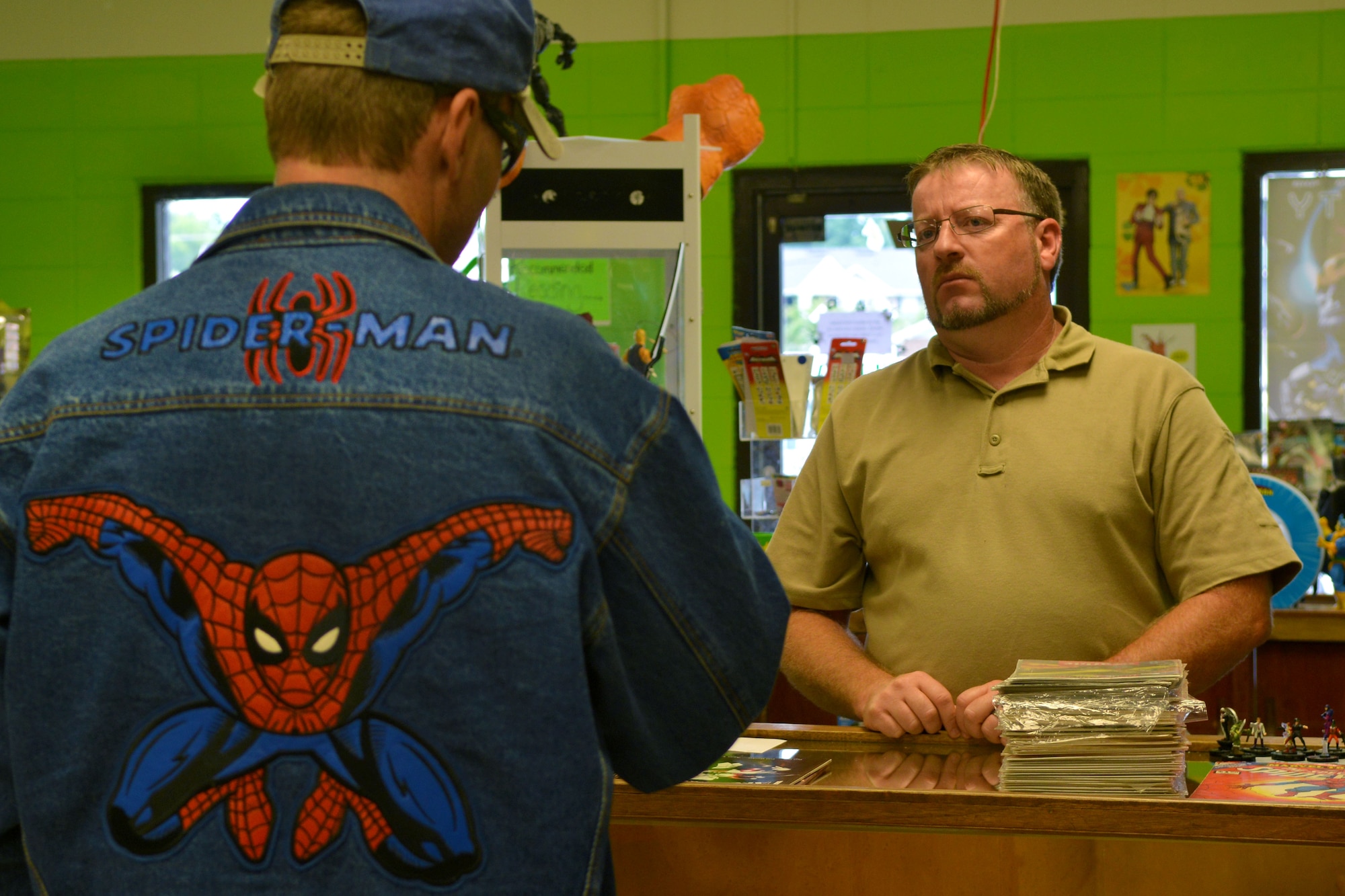 Barry Edwards, Nuklear Comix owner and a U.S. Army veteran, talks with a customer about comic book characters, Sumter, S.C., Aug. 24, 2013. The comic book store was opened by the veteran in November 2012 to bring in people who share in his passion for comic books. (U.S. Air Force photo by Airman 1st Class Ashley L. Gardner/Released)