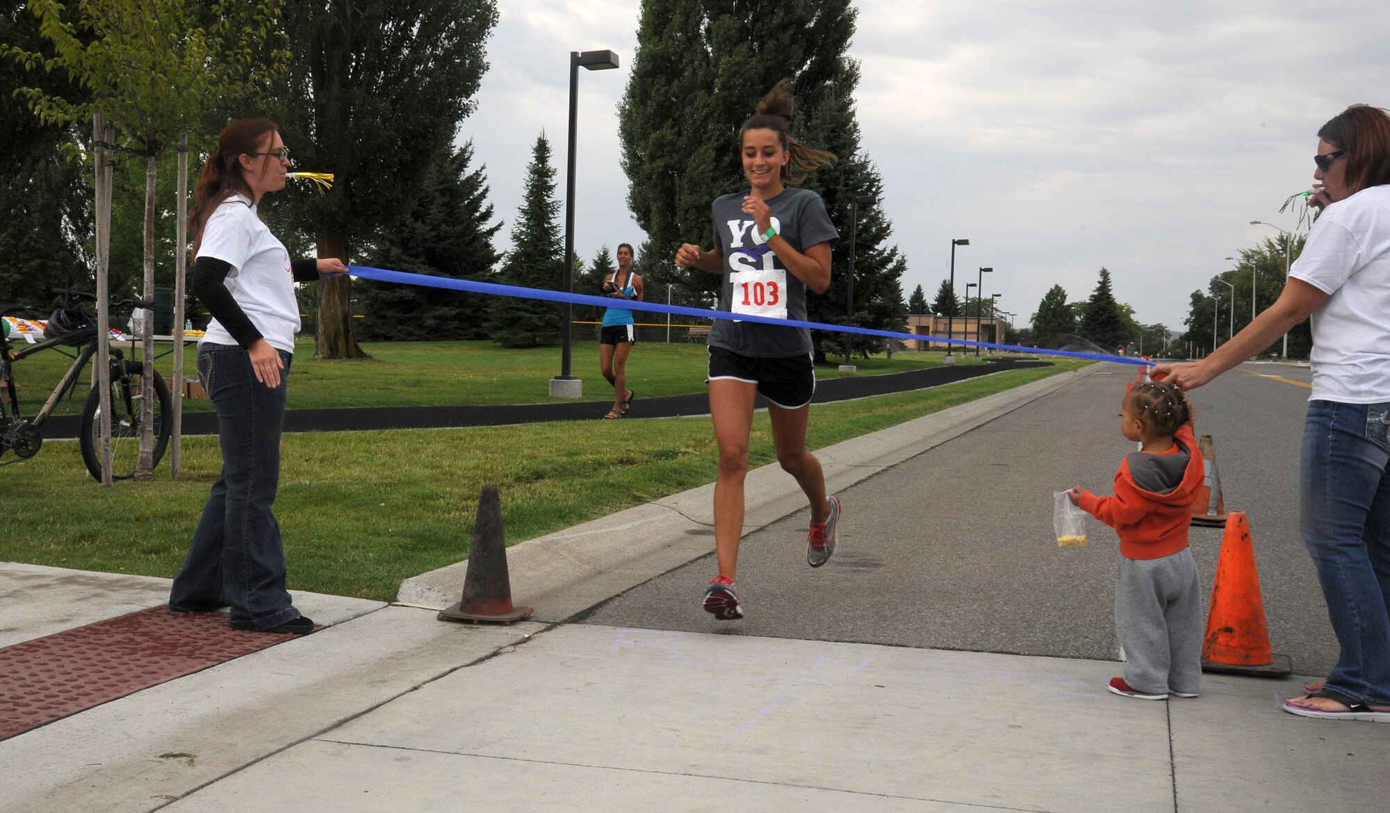 Sakaiya McCoy crosses the finish line of the Kids Wellness Triathlon at Fairchild Air Force Base, Wash., Aug. 24, 2013.  The triathlon was held to establish a fitness regimen among young people.  (U.S. Air Force photo by Airman 1st Class Sam Fogleman/Released)