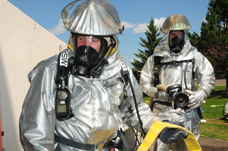 148th Fighter Wing, Duluth, Minn. firefighters prepare to enter a "simulated" burning building during a Readiness Exercise scenario on July 19, 2013.  The Air Combat Command (ACC) Inspector General team evaluated the 148FW during a Readiness Inspection (RI), Aug. 22-24, 2013, the wing received an overall grade of excellent.  (U.S. Air National Guard photo by Master Sgt. Ralph J. Kapustka/Released)