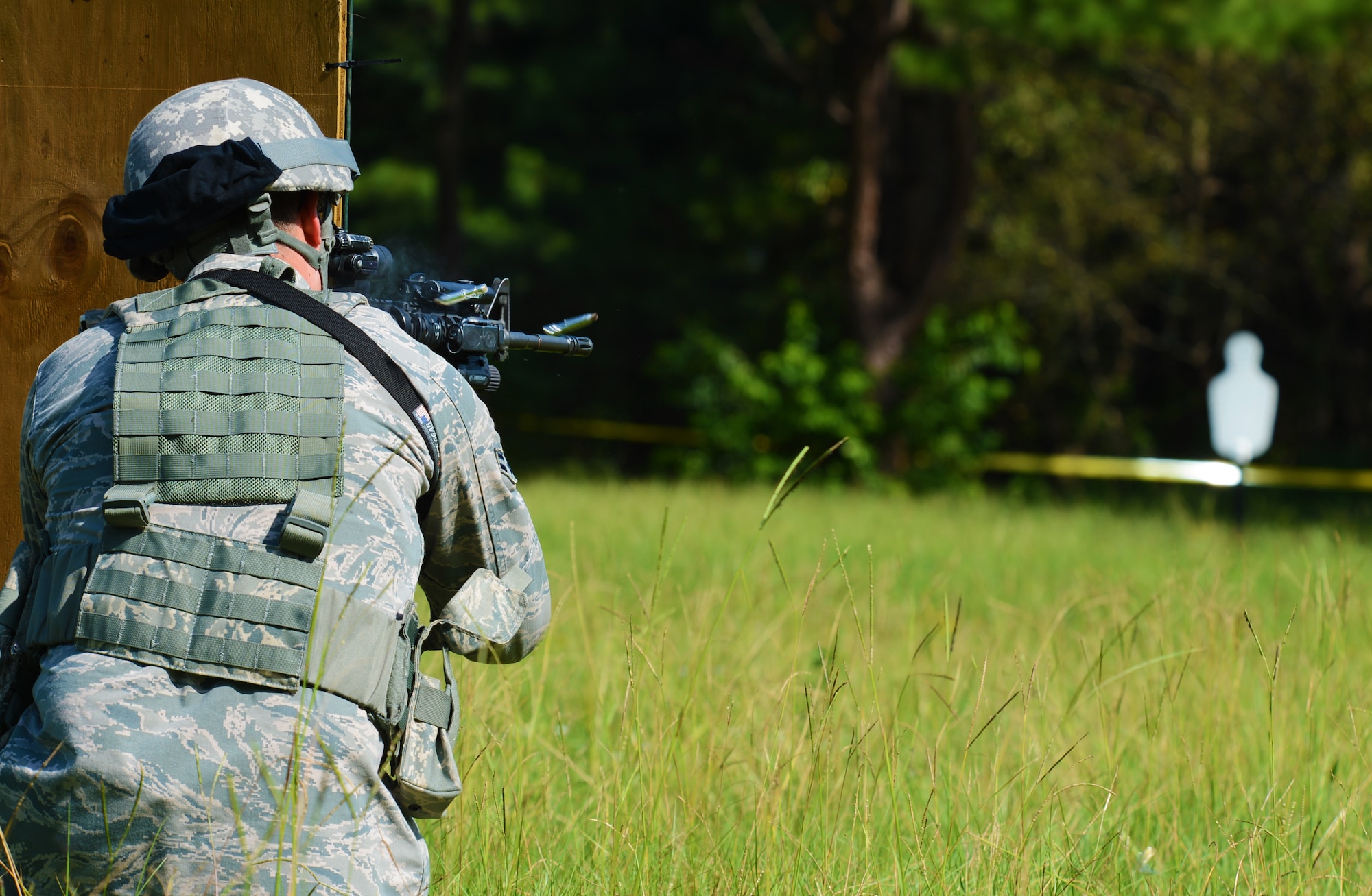 U.S. Air Force Airman 1st Class Mike Garza, 20th Security Forces Squadron installation entry controller, shoots at a given target while taking cover during a shoot, move and communicate exercise at Shaw Air Force Base, S.C., Aug. 21, 2013. Every six months, 20th SFS Airmen are required to complete an M4 carbine sufficiency training while learning to work as a team. (U.S. Air Force photo by Senior Airman Tabatha Zarrella/Released) 
