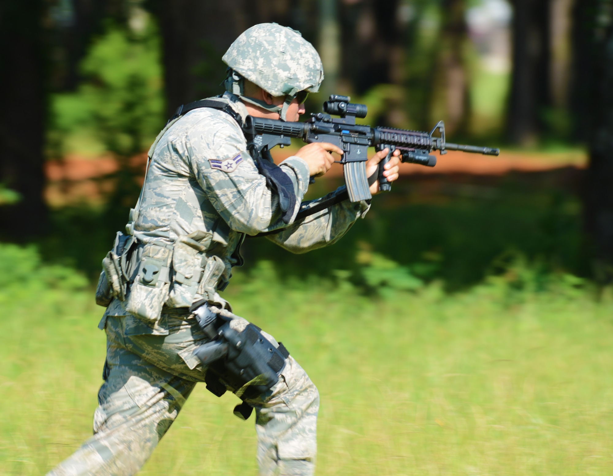 U.S. Air Force Airman 1st Class Mike Garza, 20th Security Forces installation entry controller, moves toward a given target practicing the ?move? portion of the shoot, move and communicate exercise at Shaw Air Force Base, S.C., Aug. 21, 2013. Every six months, 20th SFS Airmen are required to complete M4 carbine sufficiency training while learning to work as a team. (U.S. Air Force photo by Senior Airman Tabatha Zarrella/Released) 
