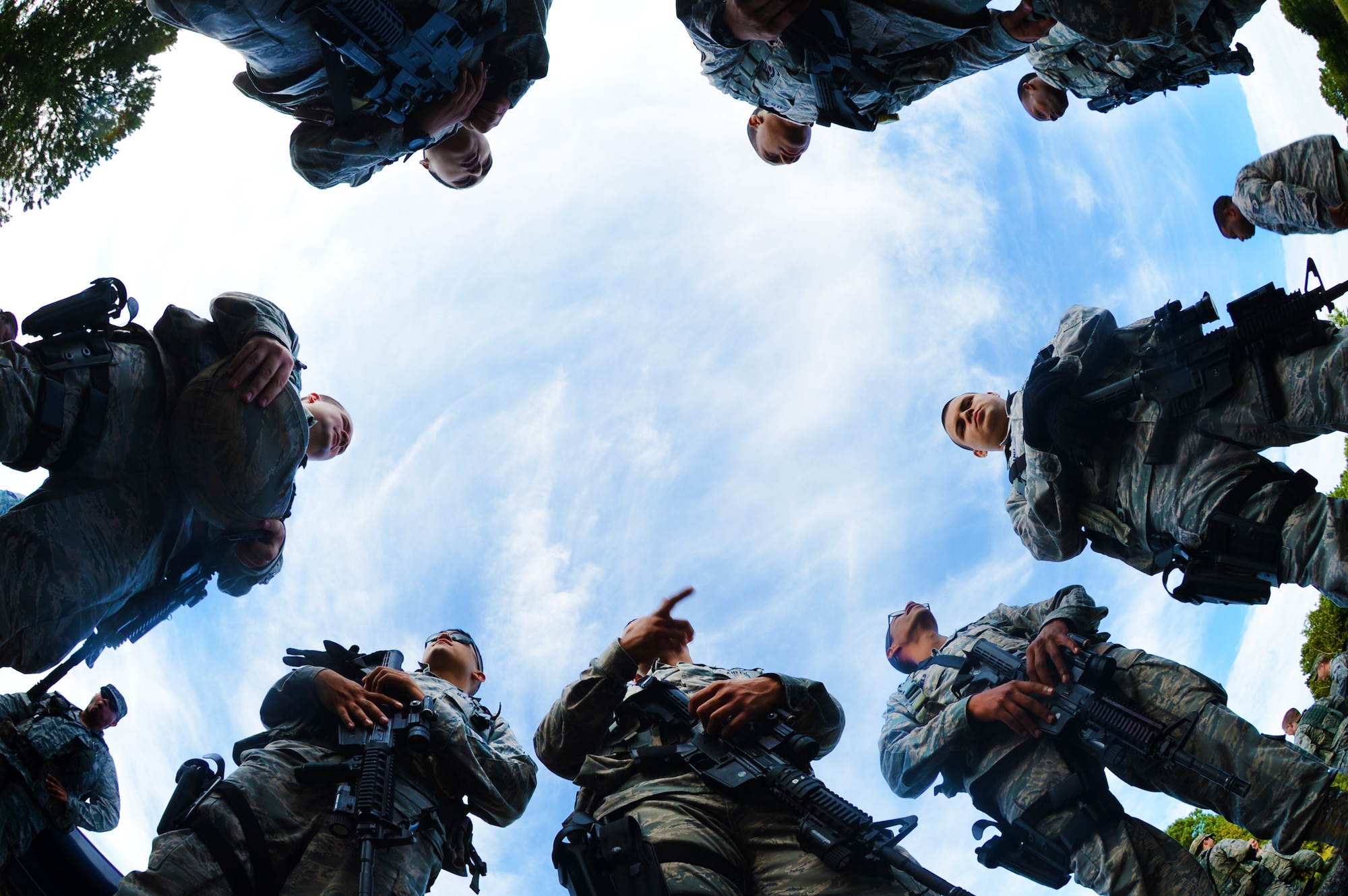 U.S. Air Force 20th Security Forces Squadron Airmen huddle to discuss teams before a shoot, move and communicate exercise begins, Shaw Air Force Base, S.C., Aug. 21, 2013. Every six months, 20th SFS Airmen are required to complete M4 carbine sufficiency training while learning to work as a team. (U.S. Air Force photo by Senior Airman Tabatha Zarrella/Released)
