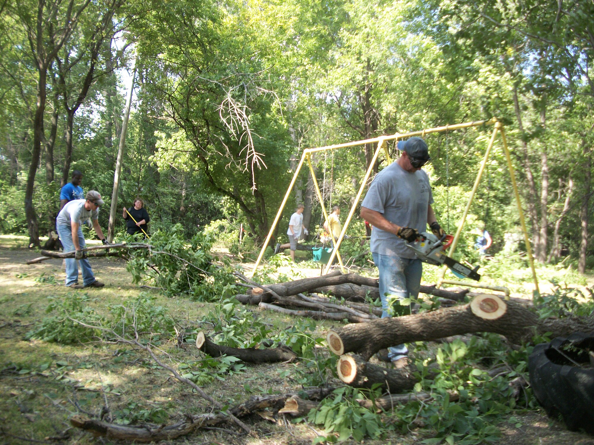 Volunteers from Grand Forks Air Force Base, N.D., do some landscaping work at Seebart Park in Emerado, N.D., Aug. 24, 2013. The base volunteers sawed, clipped, dragged and tossed about two dozen trees, and removed at least five truckloads of brush during four hours of work as part of park beautification project. (U.S. Air Force photo/Staff Sgt. Luis Loza Gutierrez)


