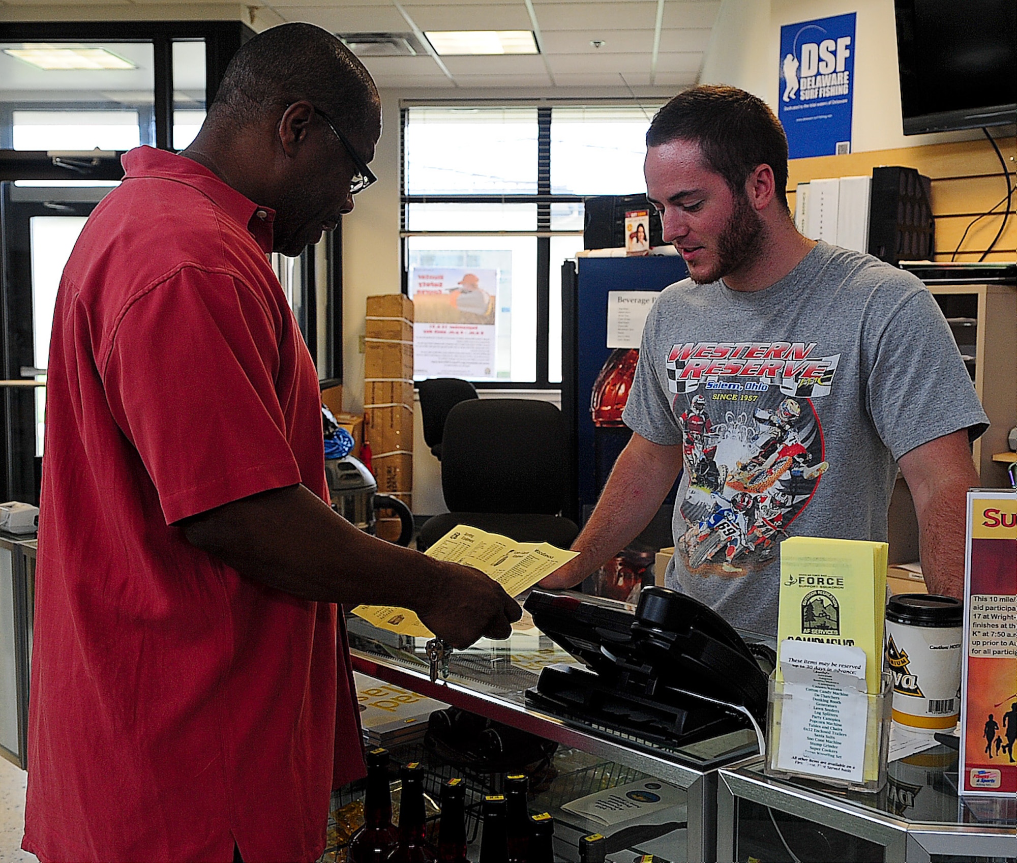 Michael Hatton, Outdoor Recreation aid, explains to Rodney Little the different equipment he can rent Aug. 23, 2013, at Outdoor Recreation on Dover Air Force Base, Del. Outdoor Recreation has equipment for all a variety of activities including canoeing, camping, mountain biking, hiking and kayaking. (U.S. Air Force photo/Airman 1st Class Ashlin Federick)
