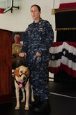Chief Petty Officer Jeannette Tarqueno, a gunner’s mate and wounded warrior, addresses the audience with her new service dog Gaza, during a ceremony Aug. 26, 2013, at the Naval Consolidated Brig Charleston, S.C. Gaza was trained by NCBC prisoners in conjunction with Carolina Canines for Service, a non-profit organization that trains service dogs for veterans with disabilities. Gaza, a Labrador retriever, will assist Tarqueno by providing more independence and comfort in her life. (U.S. Air Force photo/Airman 1st Class Chacarra Neal) 

