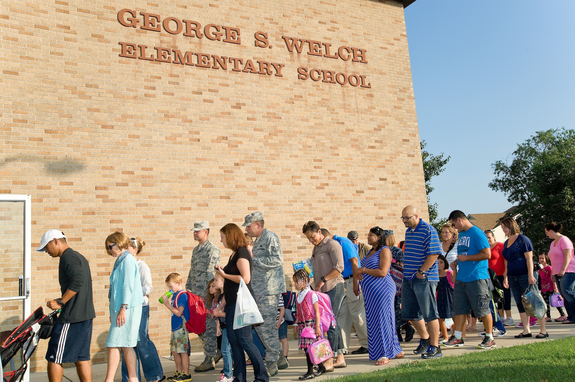 Kindergarten students and their parents enter George S. Welch Elementary School, Aug. 26, 2013, at Dover Air Force Base, Del. Parents walked their children to class for the first day of school. (U.S. Air Force photo/Roland Balik)