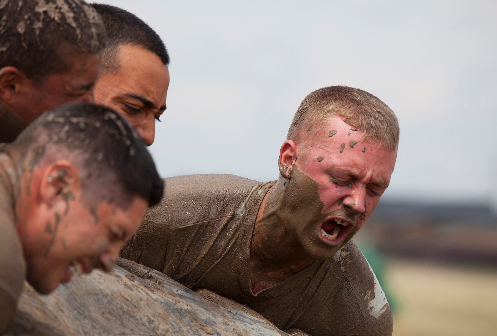 130822-F-JW079-1016
Airman 1st Class Ethan Kight, 90th Missile Security Forces Squadron Flight 1, screams in exertion as he helps his team flip a tire weighing about 350 pounds while competing in the “team pain” event in the F.E. Warren Air Force Base, Wyo., Crow Creek Challenge Aug. 22, 2013. One of the most physically demanding of the events, team pain saw teams doing team pushups in muddy water, flip a heavy tire the length of the course and then carry a log back the length of the course. The teams were graded on the number of sets they were able to complete in 15 minutes. (U.S. Air Force photo by R.J. Oriez)
