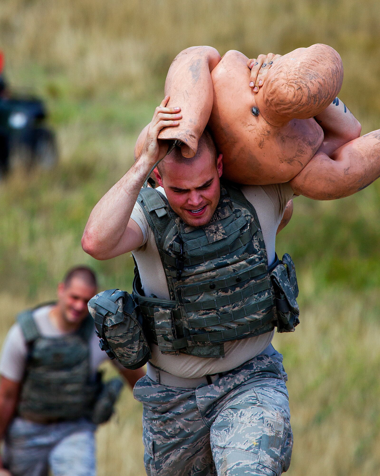 130822-F-JW079-0933
Senior Airman Andrew Marosok, 90th Missile Security Forces Squadron, races up a hill with a training dummy as teammates follow with other loads as they compete in the “ruck and pack” event in the F.E. Warren Air Force Base, Wyo., Crow Creek Challenge Aug. 22, 2013. (U.S. Air Force photo by R.J. Oriez) 

