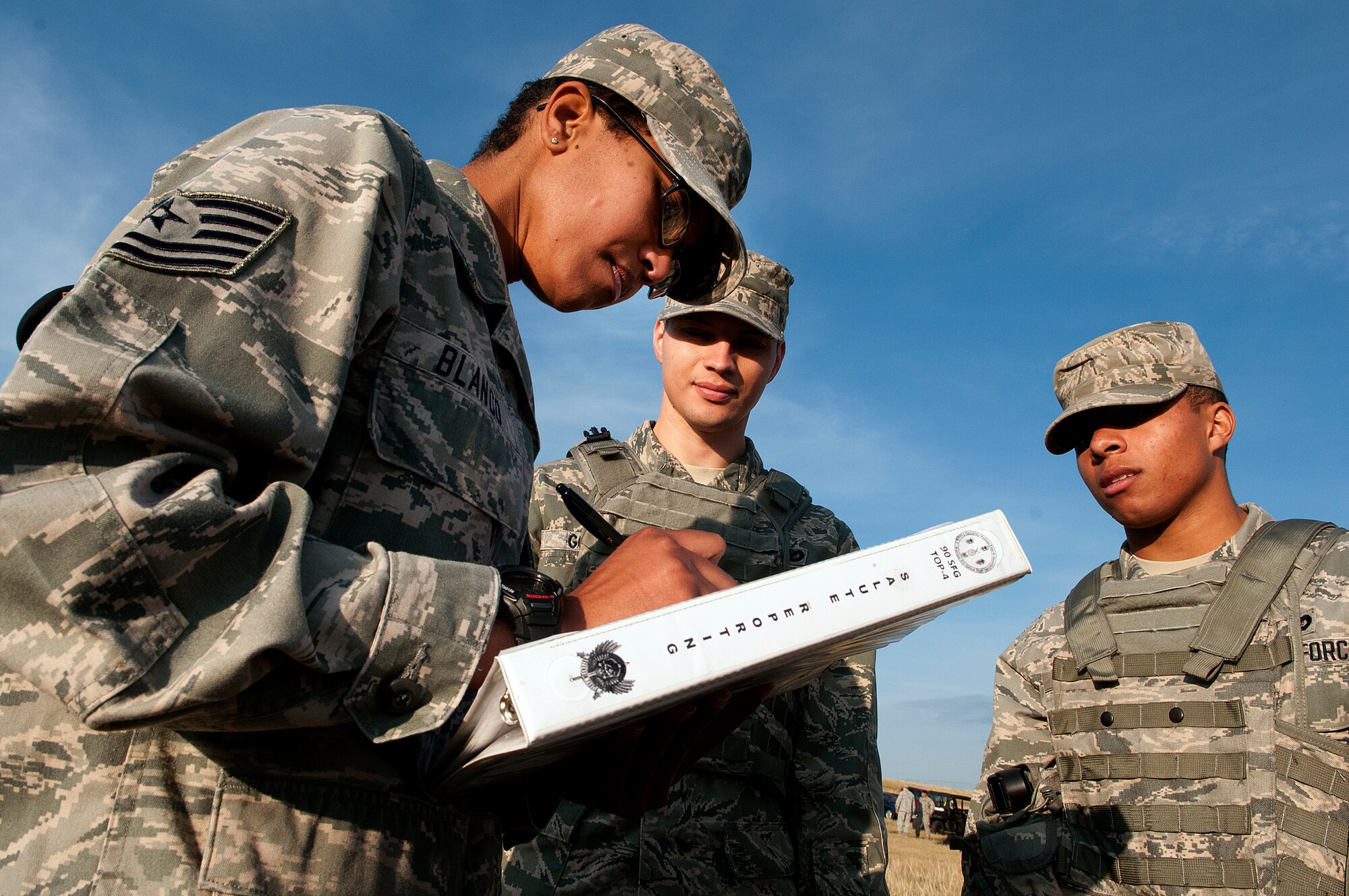 130822-F-JW079-0020
Tech. Sgt. Kim Blanco, 90th Security Forces Group, scores the 90th Missile Security Forces Squadron Flight 1 Crow Creek Challenge team in the “SALUTE” reporting, which stands for size, activity, location, unit or uniform, time, and equipment, event as team members Staff Sgt. Eric Gomez and Airman 1st Class Javon Leach, 90th MSFS, look on Aug. 22, 2013. (U.S. Air Force photo by R.J. Oriez)
