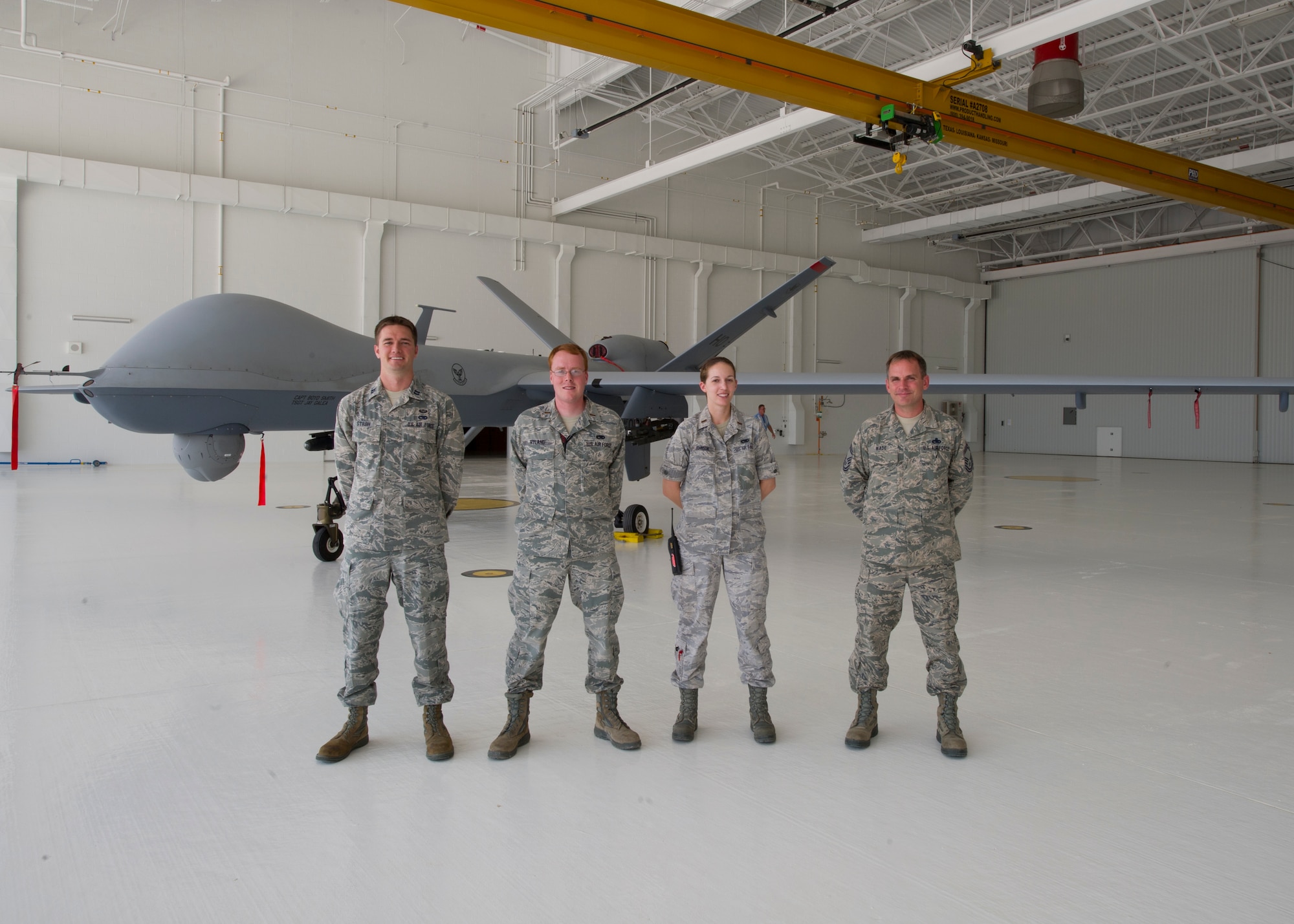 Leadership from the 849th Aircraft Maintenance Squadron poses in their new hangar at Holloman Air Force Base, N.M.,  Aug. 26. Construction on hangar three started May 12 and opened Aug. 22. The hangar will be used to house the MQ-1 and MQ-9 remotely piloted aircrafts that are used for worldwide-pilot training including numerous foreign services. (U.S. Air Force photo by Airman 1st Class Leah Murray/Released)