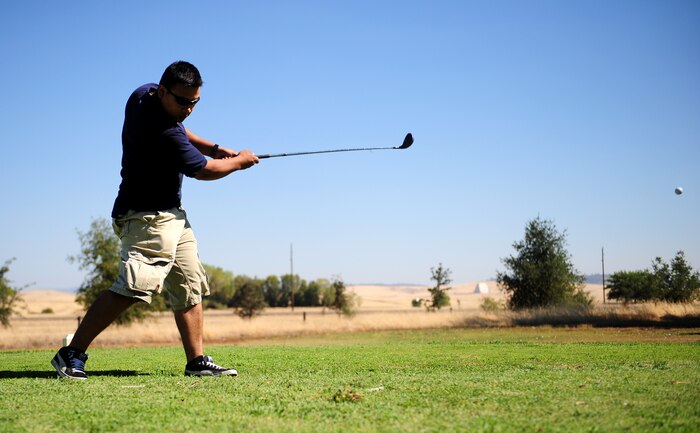 2nd Lt. Dalin Chhen, Det 11 flight commander, tees off from hole 3 at the Coyote Run Golf Course during a fundraising golf tournament at Beale Air Force Base, Calif., on Aug. 23, 2013. The $3,000 gained from the tournament will be utilized for the Air Force Ball on Sep. 21, 2013. (U.S. Air Force photo by Airman 1st Class Bobby Cummings/Released)