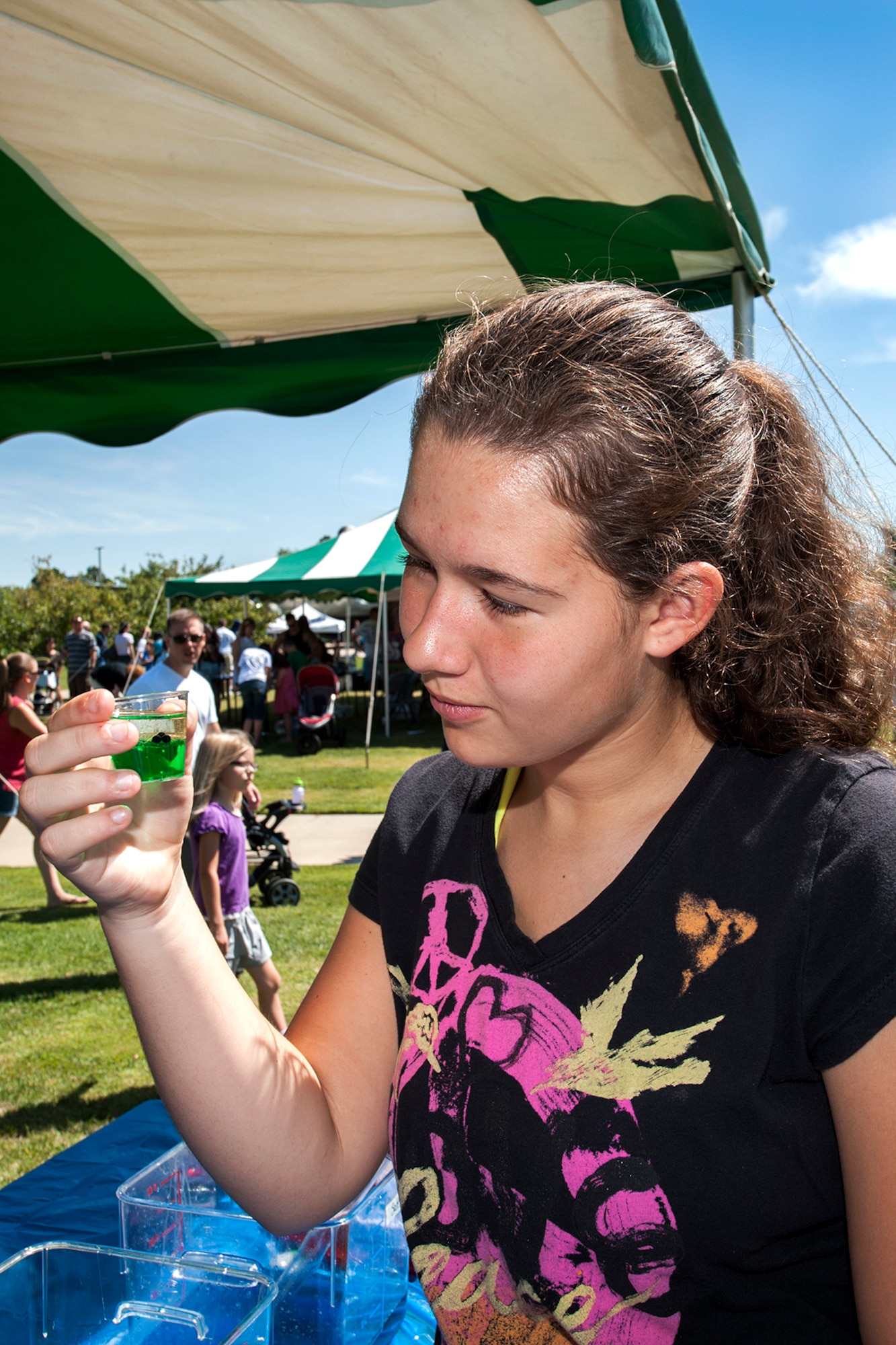 Madison Nichols learns about basic chemistry and the density of liquids at STEM Rocks! At the exhibit, Nichols learned about the interaction of oil, tap water and food coloring. The festival was held at the Peterson Air and Space Museum Aug. 24 and included hands-on activities for kindergarten to eighth graders. Some of the activities involved making slime, crawling through caves, launching rockets, building gliders, electricity demonstrations, and more interactive demonstrations. (U.S. Air Force photo/Craig Denton)