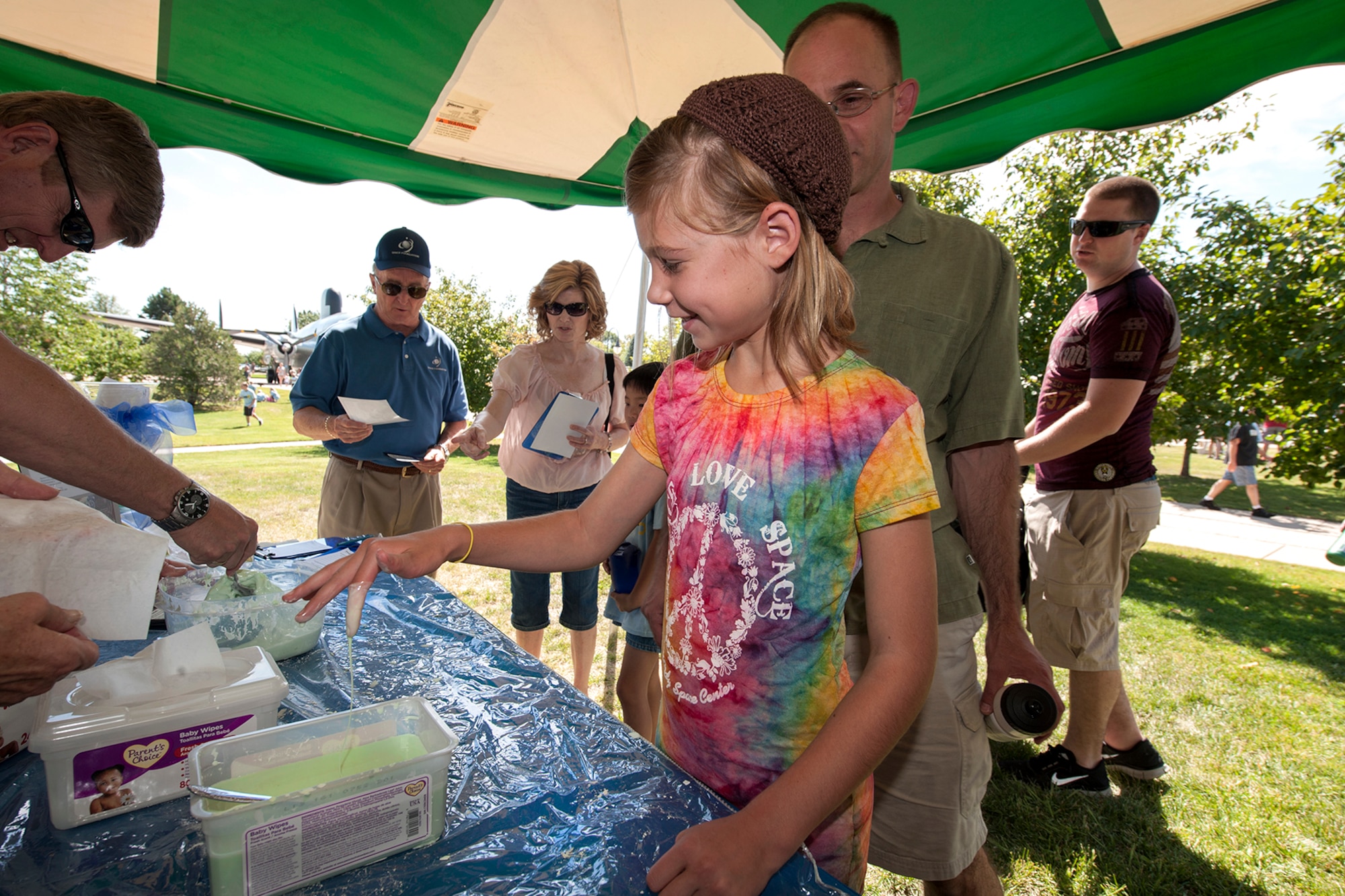 Rhyan Brennan checks out some oobleck at STEM Rocks! Oobleck feels like a solid but also feels like a liquid and can be made by mixing equal amounts of water and corn starch together, and then adding a little food coloring. The festival was held at the Peterson Air and Space Museum Aug. 24 and included hands-on activities for kindergarten to eighth graders. Some of the activities involved making slime, crawling through caves, launching rockets, building gliders, electricity demonstrations, and more interactive demonstrations. (U.S. Air Force photo/Craig Denton)