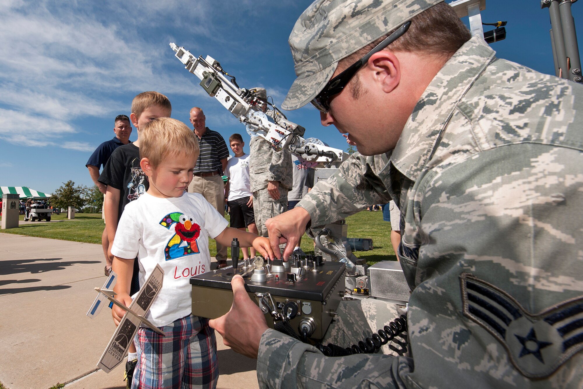 Senior Airman David Hartman, 21st Explosive Ordnance Disposal flight, shows Louis Glunta how to control the EOD robot arm during STEM Rocks! There was also a demonstration that showed how strong the grip was on the robot. The festival was held at the Peterson Air and Space Museum Aug. 24 and included hands-on activities for kindergarten to eighth graders. Some of the activities involved making slime, crawling through caves, launching rockets, building gliders, electricity demonstrations, and more interactive demonstrations. (U.S. Air Force photo/Craig Denton)