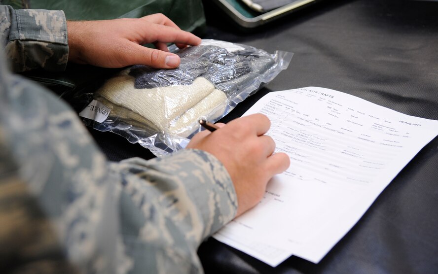 Master Sgt. Chris Scott, 2nd Operations Support Squadron NCO in-charge of Quality Assurance, checks off equipment while inspecting survival kits on Barksdale Air Force Base, La., Aug. 27, 2013. Scott's responsibilities as QA are ensuring the quality of equipment, and proper procedures are followed when kits are packed and conducting personnel evaluations to ensure Airmen receive the proper training. (U.S. Air Force photo/Airman 1st Class Andrew Moua)
