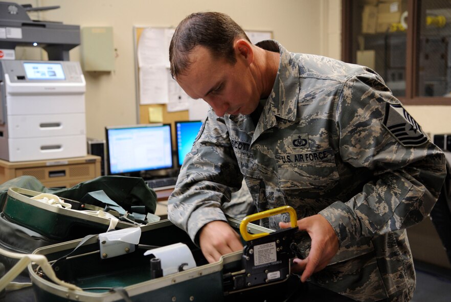 Master Sgt. Chris Scott, 2nd Operations Support Squadron NCO in-charge of Quality Assurance, inspects the interior of a CNU-129P Global Survival Kit on Barksdale Air Force Base, La., Aug. 27, 2013. The kit is stored in aircrew's seats and contains all the items needed to ensure rescue in the event of ejecting from their aircraft. (U.S. Air Force photo/Airman 1st Class Andrew Moua)