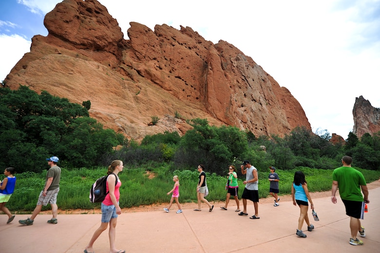 Tourists wander through Garden of the Gods Aug. 17, 2013, Colorado Springs, Colo. The 3,300-acre park is woven with more than 15 miles of climbing, hiking, walking and wheelchair-accessible trails. Rock climbing is available; however, a permit is required.  (U.S. Air Force photo by Airman 1st Class Riley Johnson/Released)