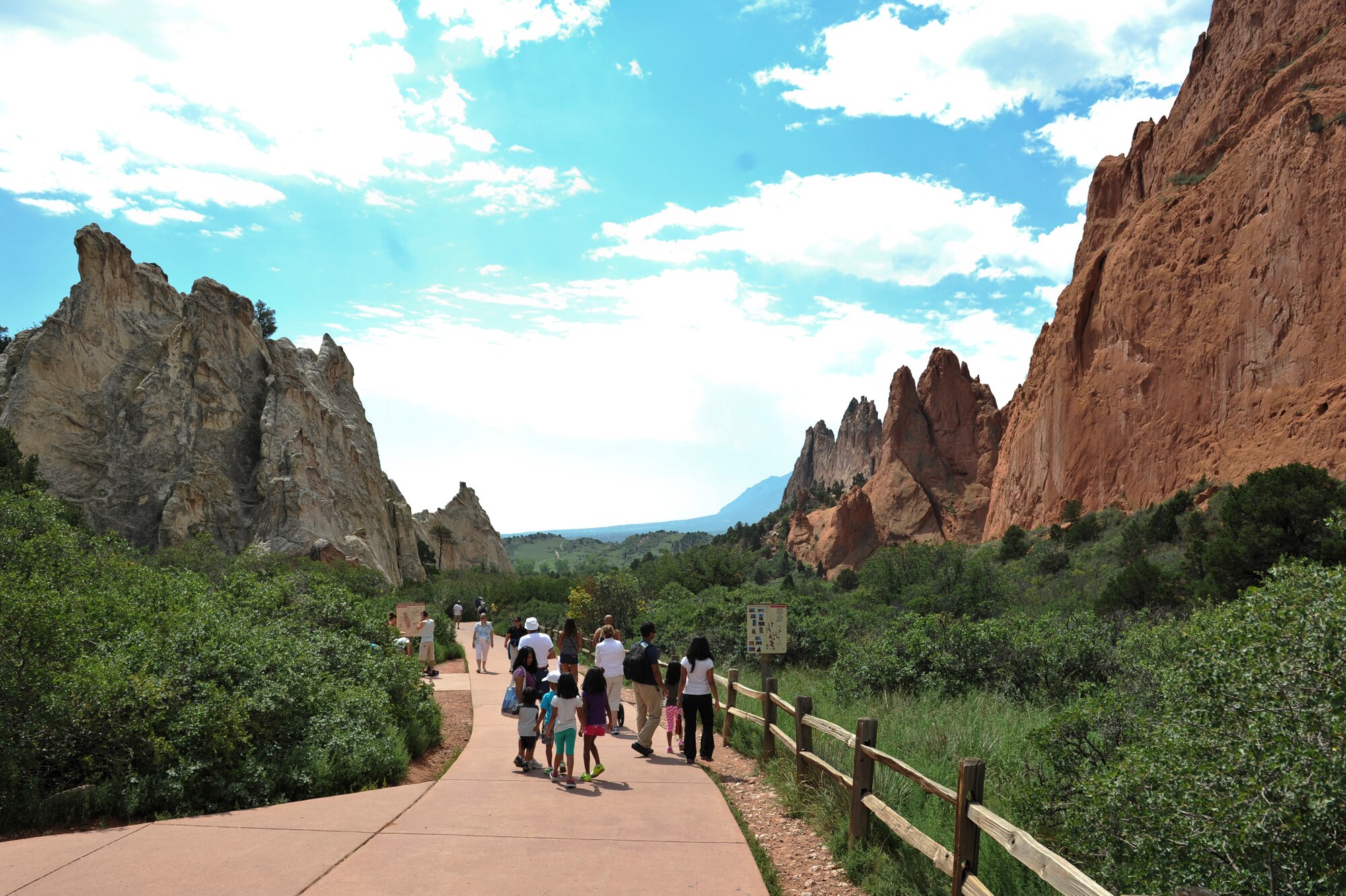 Tourists walk one of the many trails at Garden of the Gods Aug. 17, 2013, Colorado Springs, Colo. The 3,300-acre park is woven with more than 15 miles of climbing, hiking, walking and wheelchair-accessible trails. Rock climbing is available; however, a permit is required.  (U.S. Air Force photo by Airman 1st Class Riley Johnson/Released)