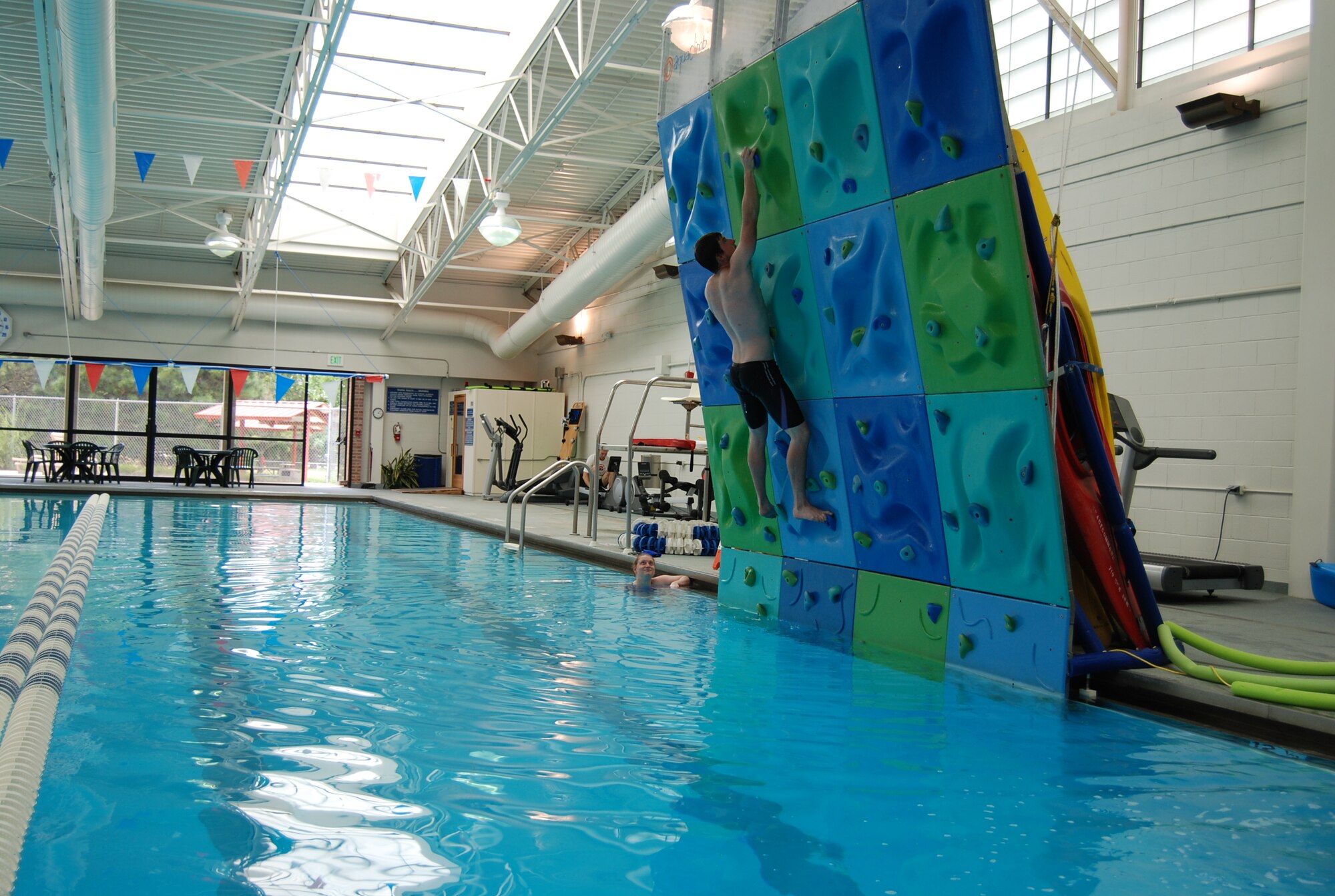 PETERSON AIR FORCE BASE, Colo. –The climbing wall at the Peterson Aquatics Center provides patrons with a safe and low-impact way to incorporate aquatic cardio and strength training. Airmen and civilians can pay a daily fee to use the facility or purchase an annual pass for the whole family. (U.S. Air Force photo/Michael Golembesky)