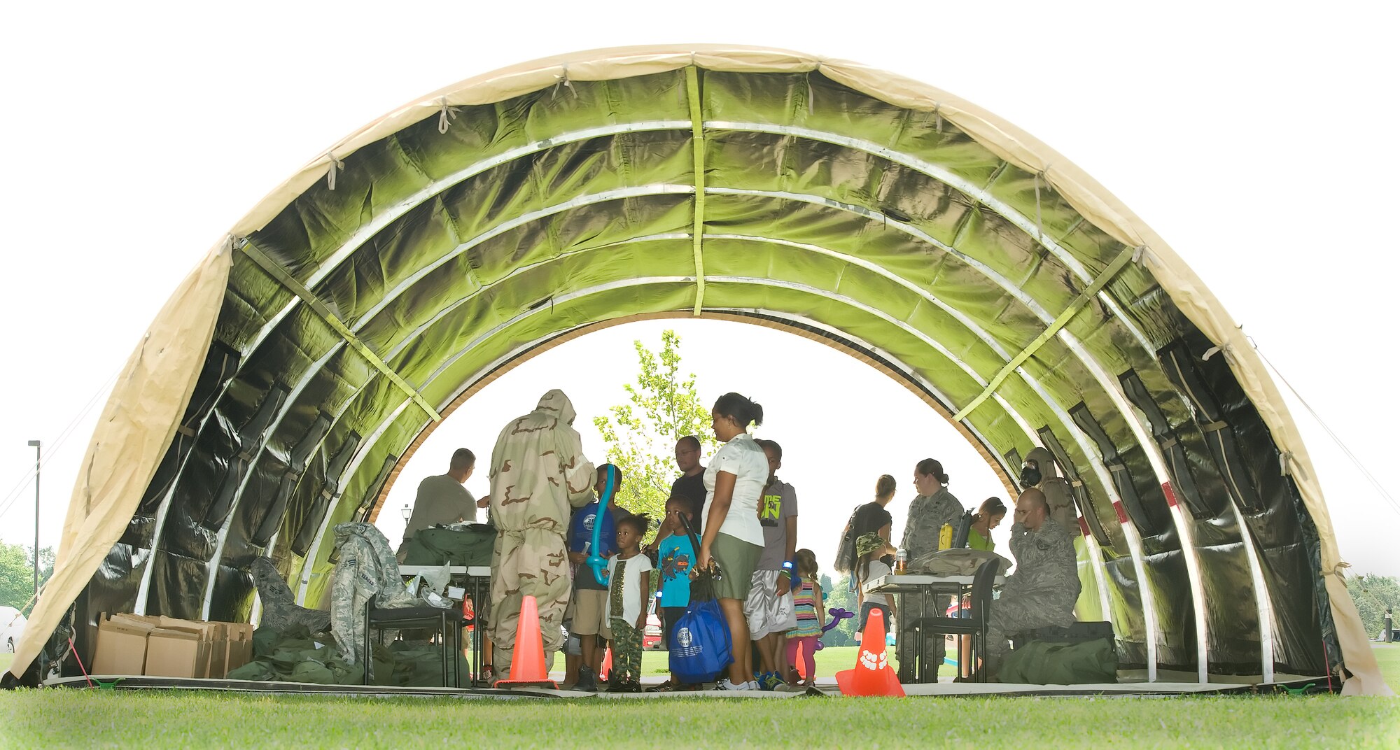 Children observe chemical weapon protective gear and aircrew flight equipment August 22, 2013, at Dover Air Force Base, Del. A tent was set up as part of the children's mobility line to familiarize them with military equipment. (U.S. Air Force photo/Roland Balik)