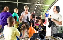 Children don chemical weapon protective gear during the children's mobility line August 22, 2013, at Dover Air Force Base, Del. Team Dover members answered questions and provided training equipment for children to try. (U.S. Air Force photo/Roland Balik)