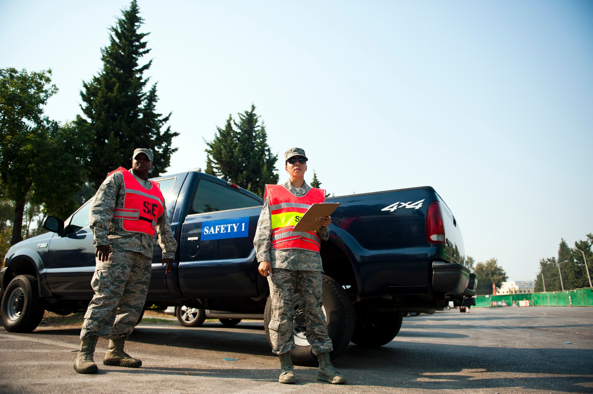 Tech. Sgts. Fatimat Bello and Angelina Manby, 39th Air Base Wing ground safety investigators, monitor traffic near the Incirlik Unit School Aug. 27, 2013, at Incirlik Air Base, Turkey. Ongoing road construction at Incirlik AB requires motorists to be extra attentive to pedestrian traffic and travel detours. (U.S. Air Force photo by Senior Airman Daniel Phelps/Released)